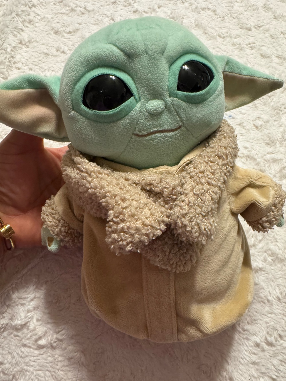Baby Yoda plush toy with beige robe and fur trim